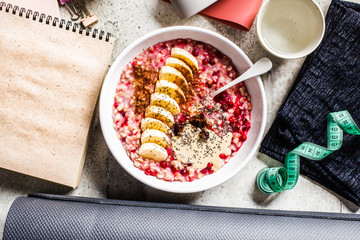 Wellness concept. Healthy food (oatmeal) and sport items, flat lay, top view. Healthy lifestyle background.