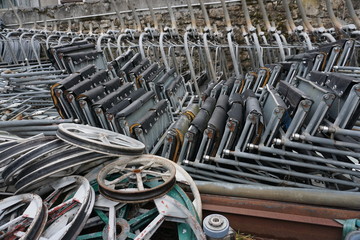 close up of rows of stacked chairlifts in a yard