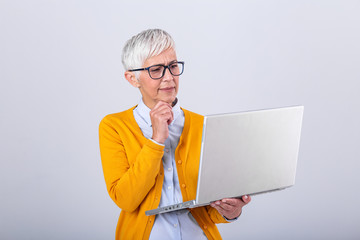 Thoughtful confused mature business woman concerned thinking about online problem looking at laptop, frustrated worried senior middle aged female reading bad email news, suffering from memory loss