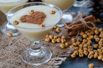Traditional turkish drink; boza with cinnamon sticks and chickpea
