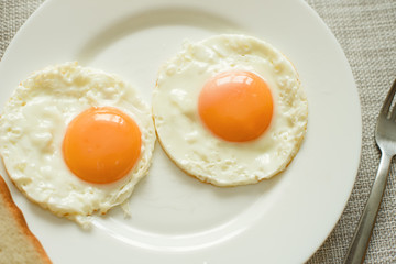 Healthy breakfast with fried eggs on wooden table