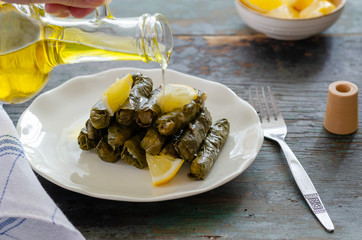 Stuffed grape leaves with rice,olive oil and herbs in white plate