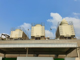 Industrial cooling towers or air cooled chillera on building roof with bluesky