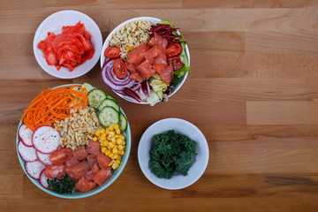 Raw fish, rice and healthy vegetables on a wooden background. Healthy eating concept