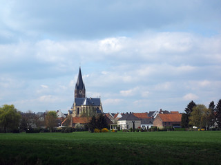 Fototapeta na wymiar View on the village Thorn with Onze Lieve Vrouwe Church and some houses in a agricultural landscape.