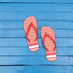 flip flops on wooden blue table