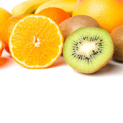 Group of tropical fruits, sliced halves of orange and kiwi isolated on white background