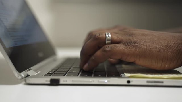 The manager is in his office typing preparing for his next meeting.