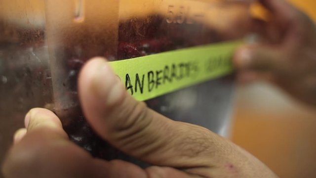 Labeling cranberries so they know when it will expire.