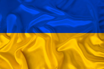 national flag of Ukraine on gentle silk with wind folds, travel concept, immigration, politics, close-up, copy space, illustration