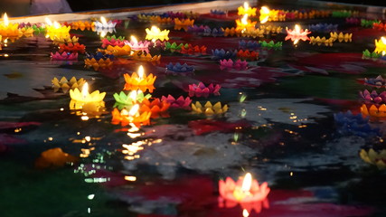 Fototapeta na wymiar Multi colored Krathong flower made with candles