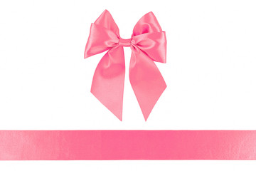Pink ribbon and bow isolated on white background