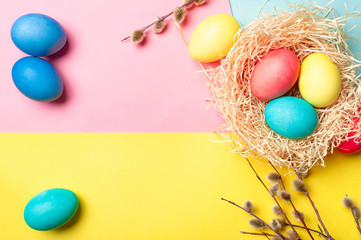 Easter concept. Colorful eggs on bright colorful background with copy space for text. Top down view or flat lay