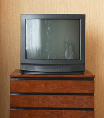 Vintage Television on wooden antique closet, old design in a home