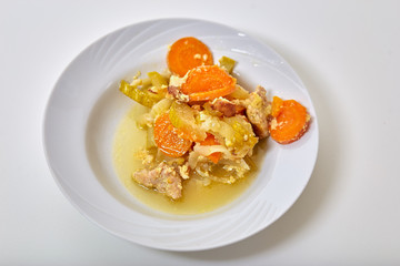 preparation of home dishes of meat with zucchini, carrots, onions and spices, close-up