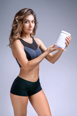woman athlete holding a white container in her hands