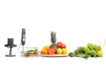 fruits and greens on a table in the studio on a white background