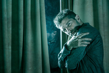 Obraz premium dramatic portrait of depressed and sick man suffering from psychosis illness or mental disorder looking weird and helpless in psychiatric and psychological problem concept