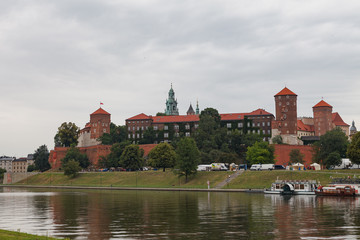 Obraz premium KRAKOW, POLAND - MAY, 2, 2018: Wawel Castle one the bank of Vistula river, Cracow, Poland.