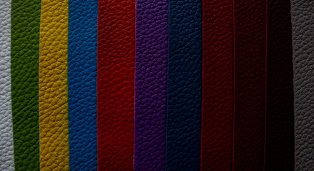 The strips of sliced, multi-coloured leather are arranged in vertical rows
