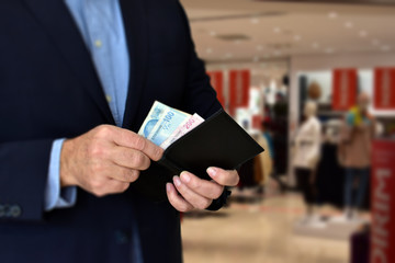 Businessman paying cash at Shopping Mall