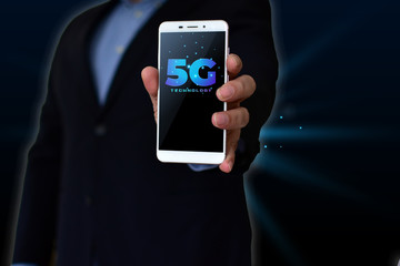 Business man holding smartphone with 5G wireless Internet, high speed internet connection