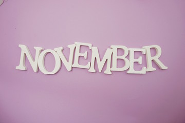 November alphabet letters on purple background