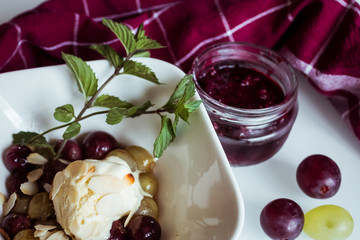 Dessert glace vanille raisins cuits menthe fraiche et coulis de framboise	