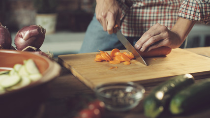 Woman slicing fresh vegetables and preparing a healthy meal