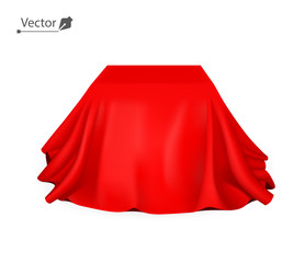 Box covered with red silk cloth. Empty podium, stand with tablecloth to show magic tricks. Secret gift, hidden under satin fabric with drapery and folds.