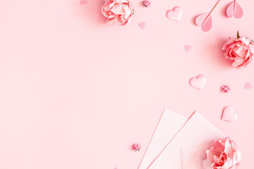 Valentine's Day background. Pink flowers, envelope, hearts on pastel pink background. Valentines day concept. Flat lay, top view, copy space - 315036747