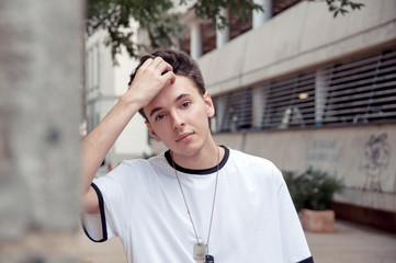 Portrait of a handsome young guy fix his hair style