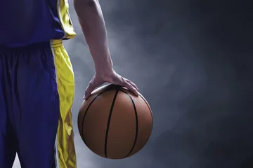 Fotobehang Basketball player holding a ball © fotokitas