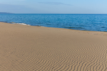 Fototapeta na wymiar View of blue sea waves at sandy beach. Horizon line. Caspian Sea, sandstone coast. ustyurt. Selective focus, long shutter speed
