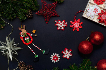 Christmas toys and decorations with balls, stars, bells and snowflakes on a black background