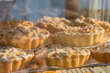Close up of pile of homemade pastry tarts with nuts and sugar icing