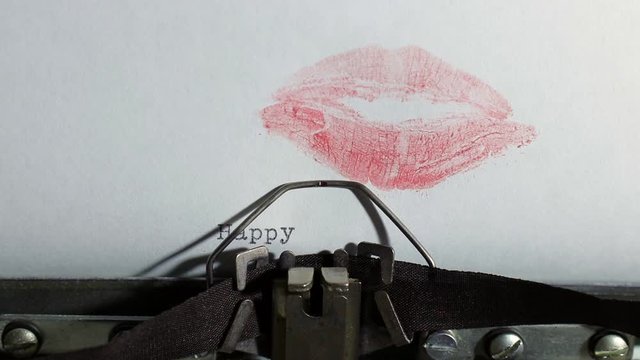 old vintage typewriter with a sheet of paper, typing the words happy valentines day with red color lipstick kiss mark, holiday and wedding day concept