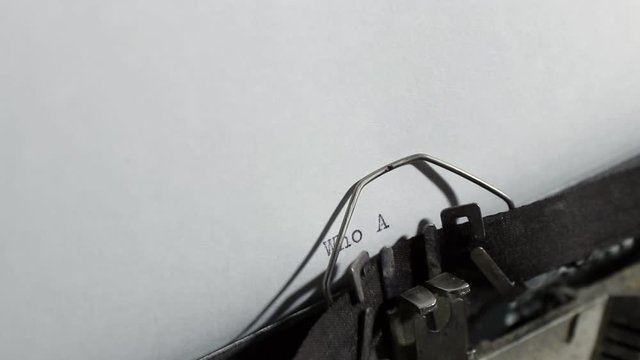 typing the words of question who are you, old vintage typewriter with a sheet of paper 
