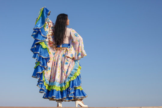 young woman dancing in gypsy dress