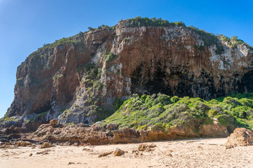 Huge rock mountain, cliff on the sand. Knysna Heads in South Africa