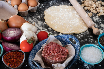 Turkish ravioli manti preparation with meat, yoghurt, butter and red pepper.