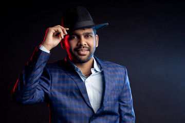 Indian young businessman on dark background