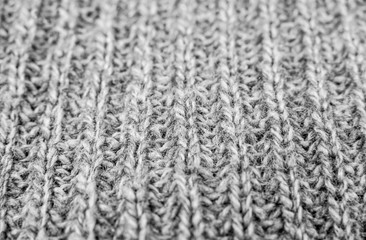Texture of gray woolen knitted sweater closeup, macro