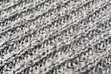 Texture of gray woolen knitted sweater closeup, macro