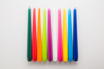 Colorful new candles on light gray table. Closeup.