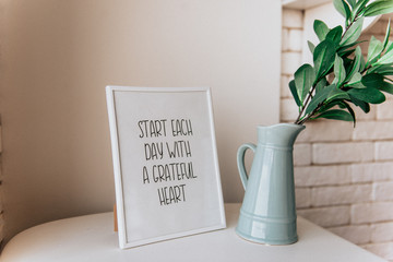 flower in vase on table in room with frame