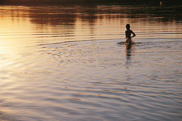 Girl taking bath on evening on the Drava River