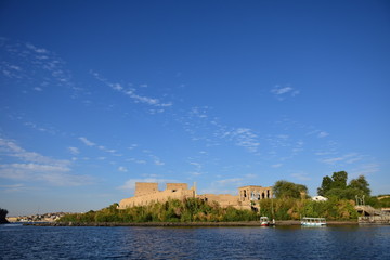 Fototapeta na wymiar Ancient pharaohs Philae temple in Aswan Egypt in the river nile , old temple have hieroglyphs craved in its stones/Trajan's Kiosk / obelisk , Ancient Egypt Monuments 