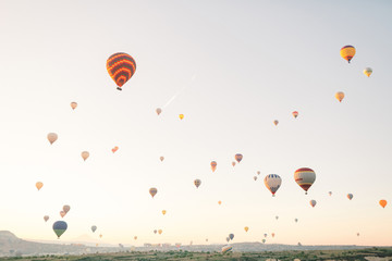 Colorful hot air balloons flying over the valley in Cappadocia, Turkey