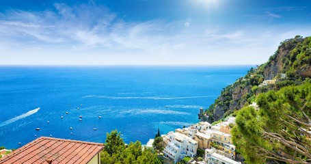 Fototapeta premium Beautiful Positano on hills leading down to coast and azure sea.